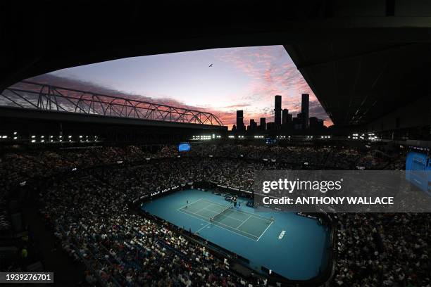 The sunset sky is pictured over Rod Laver Arena during the women's singles match between Poland's Iga Swiatek and Czech Republic's Linda Noskova on...
