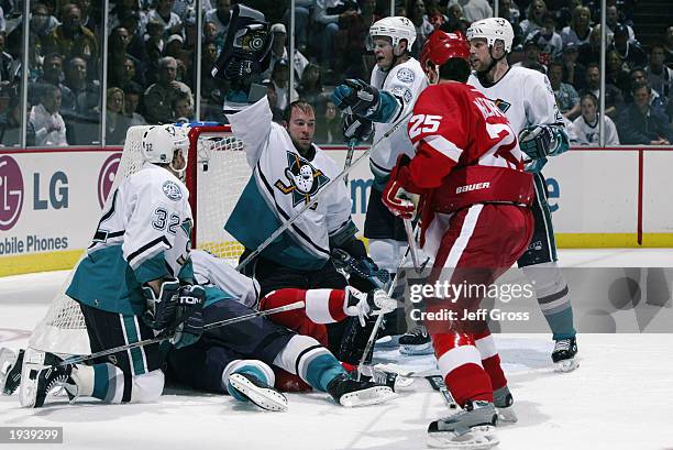 Jean-Sebastien Giguere of the Mighty Ducks of Anaheim shows the puck after making a save against the Detroit Red Wings during round one of the 2003...