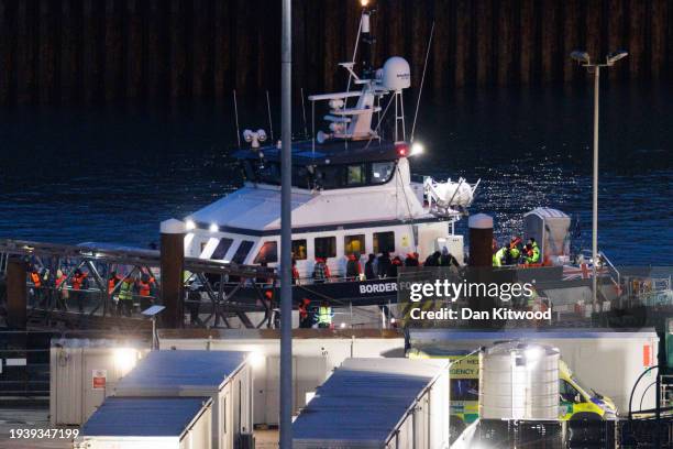 Migrants are brought ashore after being picked up in the English Channel by a Border Force vessel on January 17, 2024 in Dover, England. The first...