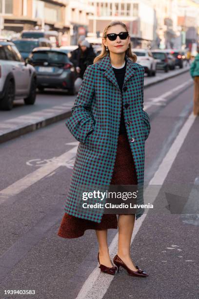 Jenny Walton wears blue and burgundy checked coat, burgundy midi skirt, burgundy kitten heels and black sunglasses, outside MSGM, during the Milan...