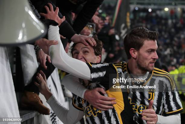Federico Chiesa of Juventus celebrates with Daniele Rugani and the fans after scoring the team's third goal during the Serie A TIM match between...