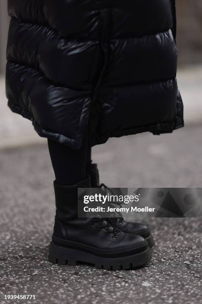 Sonia Lyson seen wearing Aritzia black shiny puffer nylon hooded long winter coat, Lululemon black leggings and Copenhagen Studios black leather...