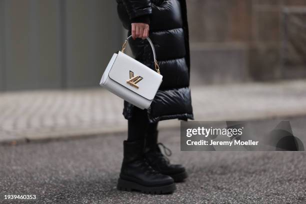 Sonia Lyson seen wearingAritzia black shiny puffer nylon hooded long winter coat, Lululemon black leggings, Louis Vuitton white leather Twist bag and...