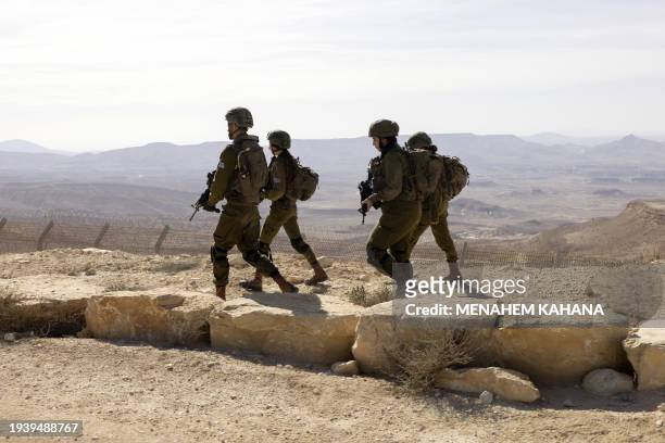 Israeli women soldiers, from the mixed gender infantry unit of the Bardelas battalion, take part in a training exercise along the Israel-Egypt border...