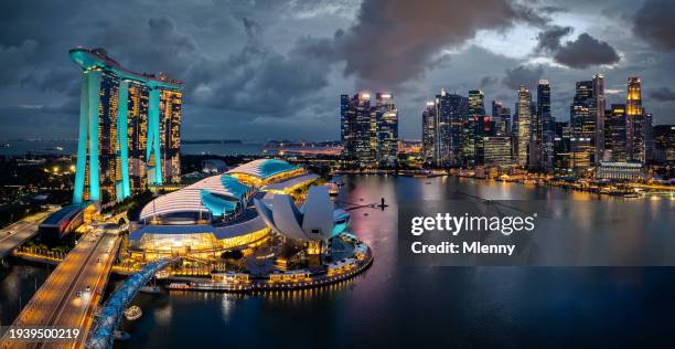 singapore cityscape at night twilight drone flight panorama - singapore pool stock pictures, royalty-free photos & images