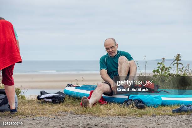 getting dressed after paddle boarding - two human feet stock pictures, royalty-free photos & images