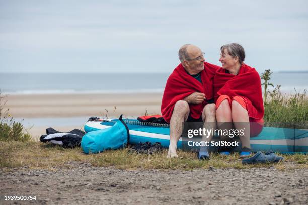 getting dried together after paddle boarding - close to stock pictures, royalty-free photos & images