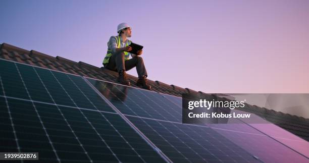 construction site, man and solar panel on roof with tablet, sunset or typing for renewable energy. people, engineer or thinking on rooftop, digital touchscreen or photovoltaic development for ecology - solar panel engineer stock pictures, royalty-free photos & images