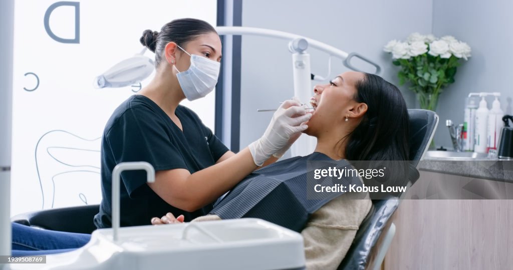 Dentist, woman and patient with tools for teeth whitening, oral hygiene and consultation with mask. Healthcare, specialist and person for mouth wellness, dental service and check for gum bacteria