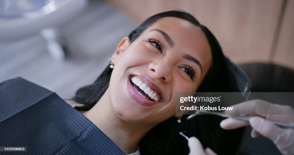 Dentist, woman and smile with mirror for teeth whitening, oral hygiene and consultation with gloves. Healthcare, specialist and patient for mouth wellness, dental service and check for gum bacteria