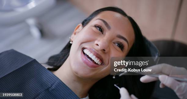 dentist, woman and smile with mirror for teeth whitening, oral hygiene and consultation with gloves. healthcare, specialist and patient for mouth wellness, dental service and check for gum bacteria - equipamento dentário imagens e fotografias de stock