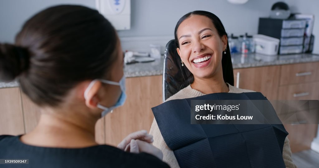 Women, dentist and patient with smile, wellness and oral health, consultation and check mouth with orthodontics. People, medical treatment or professional with dental hygiene, clinic and clean cavity