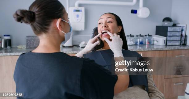 dentist, woman and patient with consulting for teeth whitening, oral hygiene and orthodontics with mask. healthcare, specialist or person for mouth wellness, dental service or check for gum bacteria - bubble gum stock pictures, royalty-free photos & images
