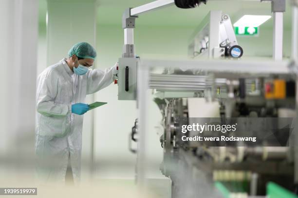 technician working in controlled environments protect the contamination of production, automated production line, cleanroom production - robotic process automation concept stock pictures, royalty-free photos & images