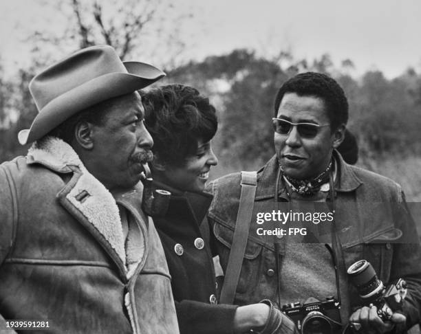 American photographer, author and film director Gordon Parks on the set of 'The Learning Tree' with his son Gordon Parks Jr and wife Elizabeth...