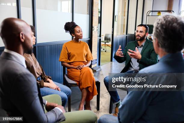 manager talking with his team during a casual meeting in an office - focus group discussion stock pictures, royalty-free photos & images