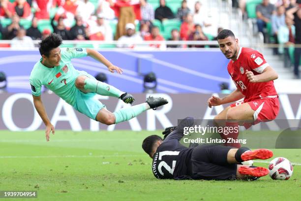 Wu Lei of China is challenged by Mostafa Matar of Lebanon during the AFC Asian Cup Group A match between Lebanon and China at Al Thumama Stadium on...