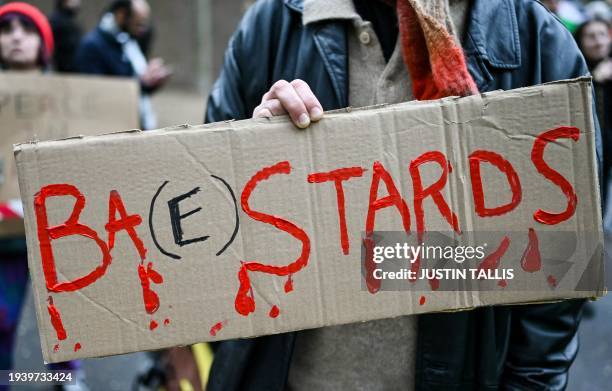 Pro-Palestinian supporter holds a placard while taking part in a "Day of Action for Palestine" demonstration outside the British multinational arms,...