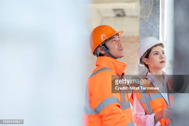 construction costs are managed better with a construction management solution on your project site. a construction foreman and site manger on construction site while checking the progress together. - manger stock pictures, royalty-free photos & images
