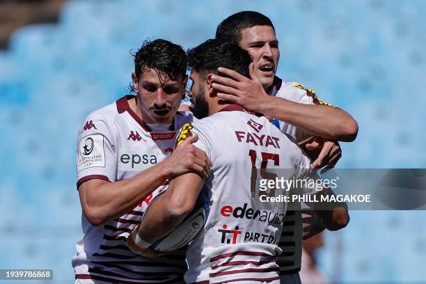 Bordeaux-Begles' French fullback Romain Buros celebrates with teammates after scoring a try during the European Rugby Champions Cup Pool 1 rugby...