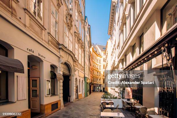narrow alley with cafes and restaurant in vienna old town on a sunny day, austria - austrian culture stock pictures, royalty-free photos & images