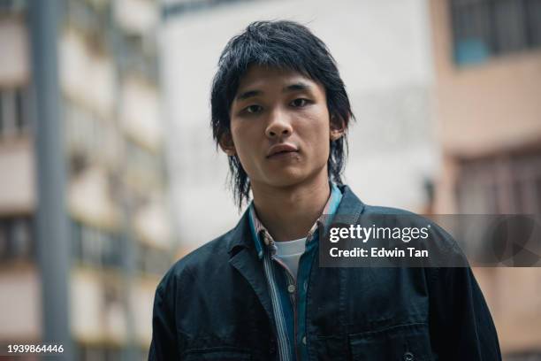 portrait asian chinese young man looking at camera with black expression - east asia stock pictures, royalty-free photos & images