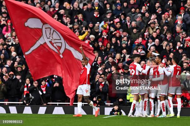 Arsenal's Belgian midfielder Leandro Trossard celebrates with teammates after scoring his team third goal during the English Premier League football...