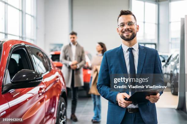 portrait of a sales executive - car dealership showroom stock pictures, royalty-free photos & images