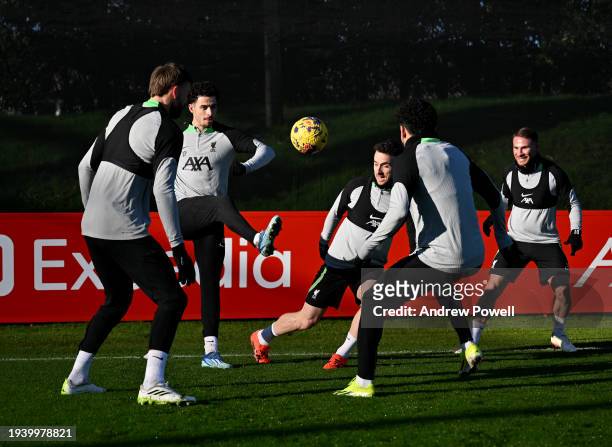 Curtis Jones and Diogo Jota of Liverpool during a training session at AXA Training Centre on January 17, 2024 in Kirkby, England.
