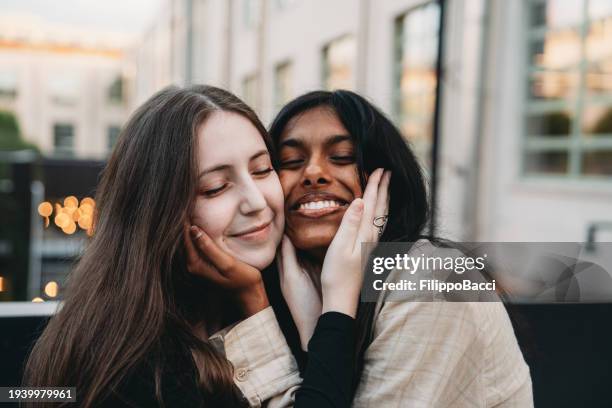 two friends are embracing together - indian lesbian stock pictures, royalty-free photos & images