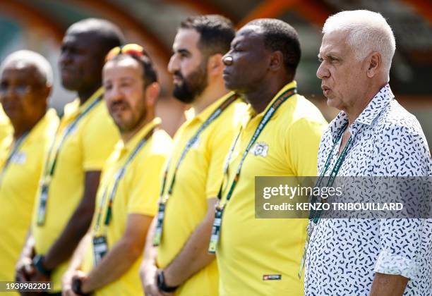 Burkina Faso's French coach Hubert Velud sings the national anthem during the Africa Cup of Nations 2024 group D football match between Algeria and...