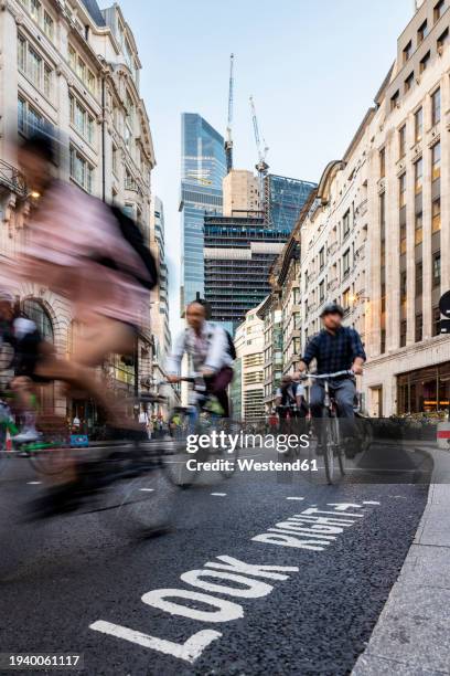 people cycling on road in city of london, uk - in sport stock pictures, royalty-free photos & images