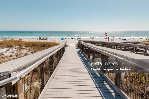 straight view from the wooden walkway over the dunes to the beach and ocean, henderson beach state park, destin, florida, usa - florida v florida state stock pictures, royalty-free photos & images