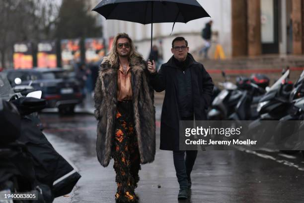 Bill Kaulitz seen wearing Gucci brown tortoise pilot sunglasses, gold piercings, gold earrings / hoops, gold necklaces, light orange satin / silk...
