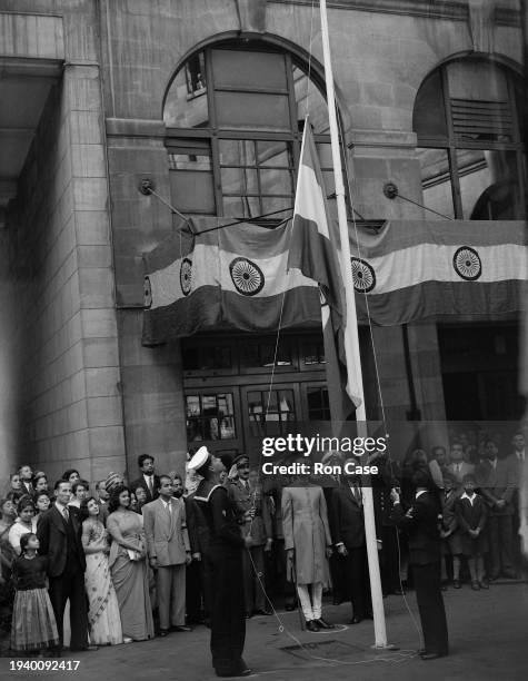 The National flag of India being hoisted watched by the High Commissioner V. K. Krishna Menon and Christopher Addison, 1st Viscount Addison , Lord...