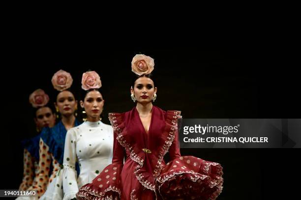 Models present creations by Alonso Cozar during the International Flamenco Fashion Week - SIMOF in Seville on January 20, 2024.