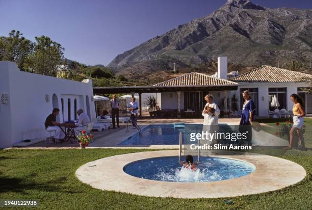 Terry von Pantz, wearing white gown, with guests at her home in Marbella, Spain, August 1980.