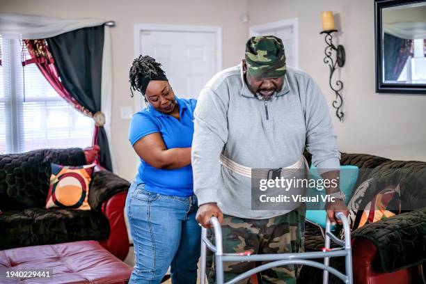 veteran using a mobility walker - home health care team stock pictures, royalty-free photos & images