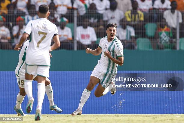 Algeria's forward Baghdad Bounedjah celebrates with teammates after scoring his team's first goal during the Africa Cup of Nations 2024 group D...