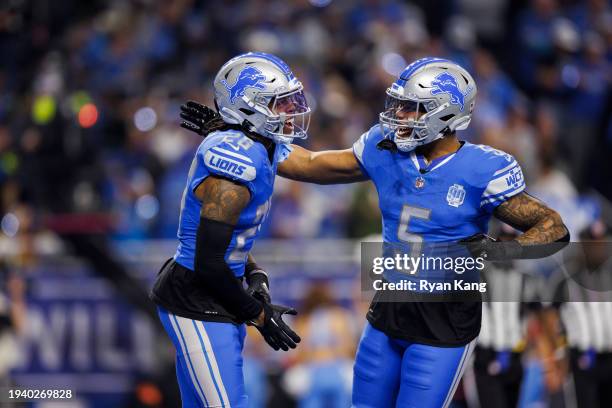 Jahmyr Gibbs celebrates with running back David Montgomery of the Detroit Lions after scoring a touchdown during an NFC Wild Card Playoff football...