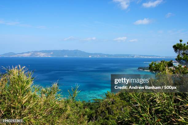 scenic view of sea against sky - okinawa blue sky beach landscape stockfoto's en -beelden