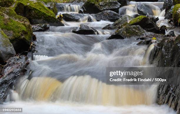 scenic view of waterfall - vatten stock-fotos und bilder