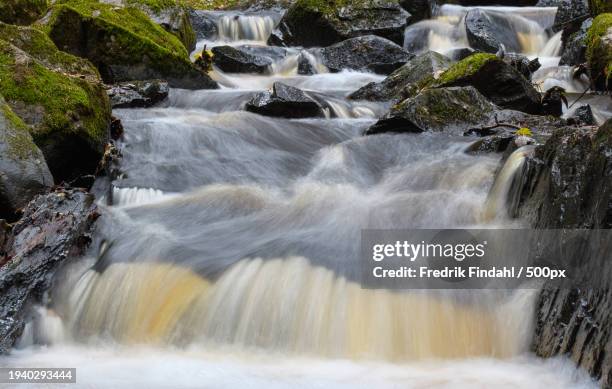 scenic view of waterfall - vätska stock pictures, royalty-free photos & images