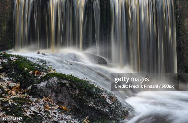 scenic view of waterfall - vatten stock-fotos und bilder