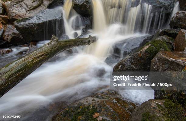 scenic view of waterfall - vätska stock pictures, royalty-free photos & images