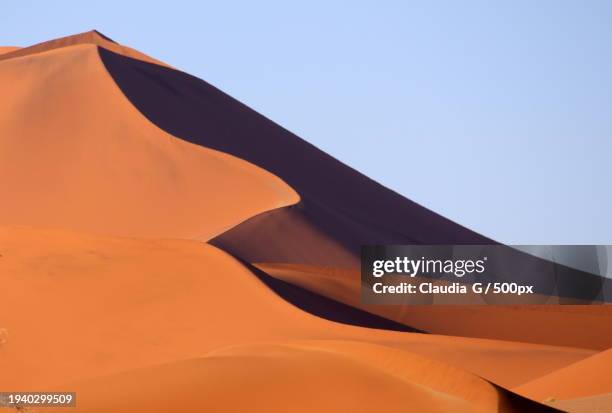 low angle view of desert against clear sky - erg chebbi desert stock pictures, royalty-free photos & images