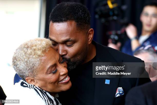 Newly appointed head coach Jerod Mayo of the New England Patriots kisses his mother Denise Mayo-Hinds following a press conference at Gillette...