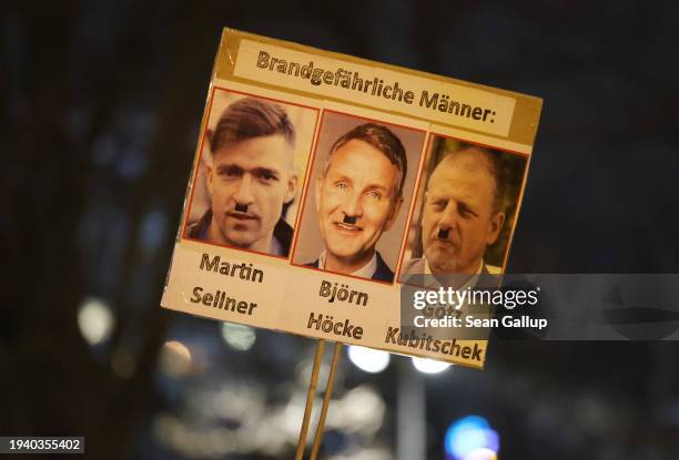 Participant holds up a sign showing Austrian right-wing extremist Martin Sellner, AfD head in the state of Thuringia Bjoern Hoecke and German...