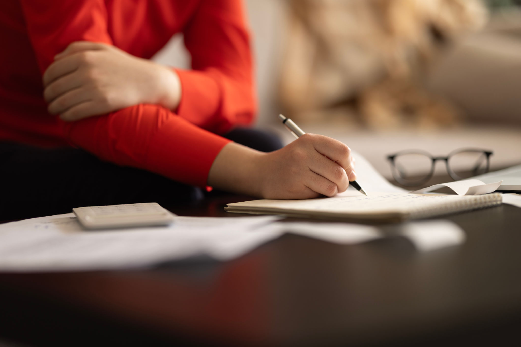 Woman is calculating the cost of the bill. Woman is calculating the cost of the bill.