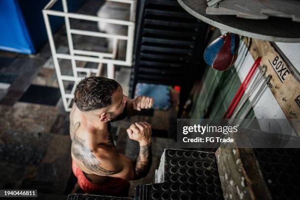 boxer man training with speed bag on a boxing gym - boxing speed bag stock pictures, royalty-free photos & images